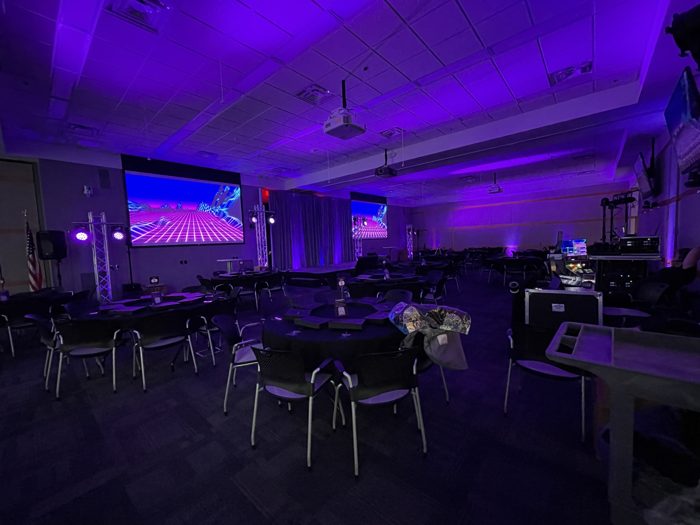 Retro synthwave graphics projected in a meeting room